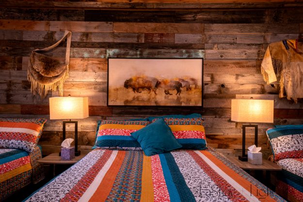 rustic cabin interior decor bedroom with buffalo painting and quilt