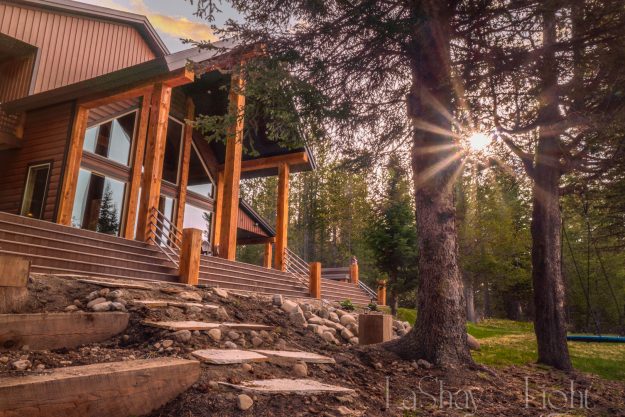 Riverfront Retreat cabin with forest and sunburst