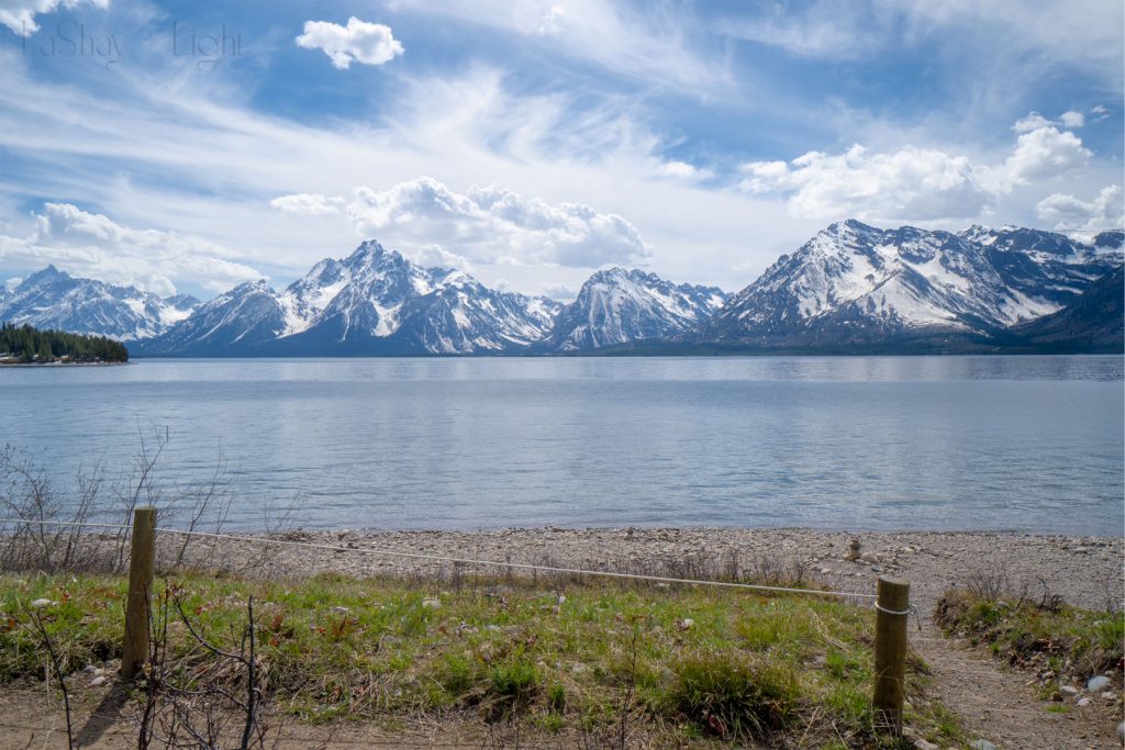 grand tetons with beach fence in the foreground