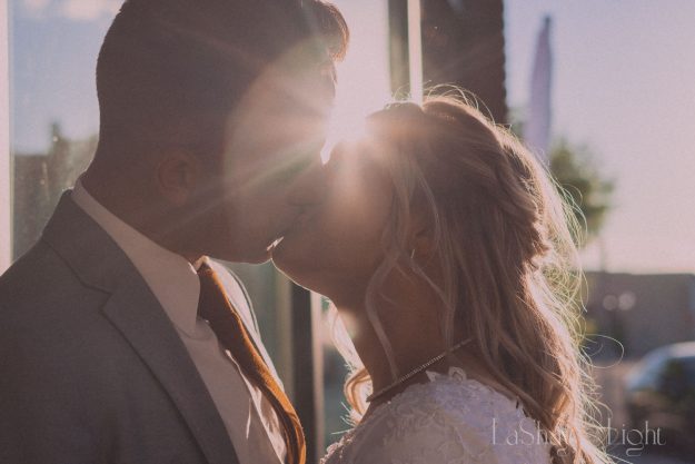 the venue bridals in rigby idaho couple kissing with sunflare
