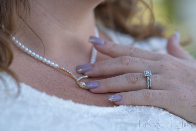 bride touching her necklace