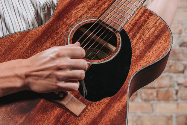 wedding musician strumming his acoustic guitar