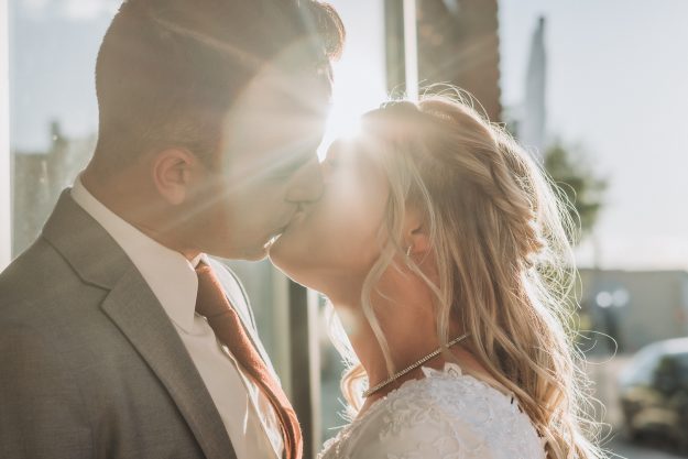 the venue bridals in rigby idaho couple kissing with sunflare
