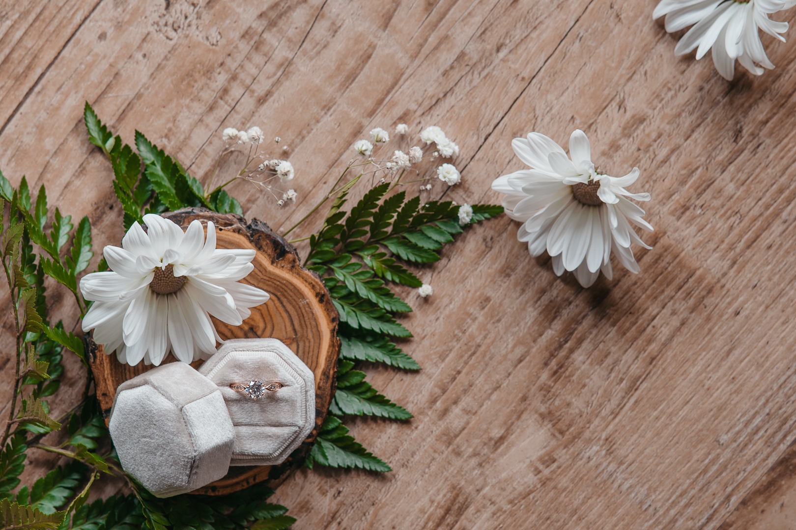 wedding ring with ferns and daisies around it