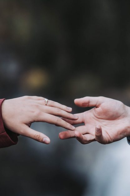 elopement couple reaching out to hold hands