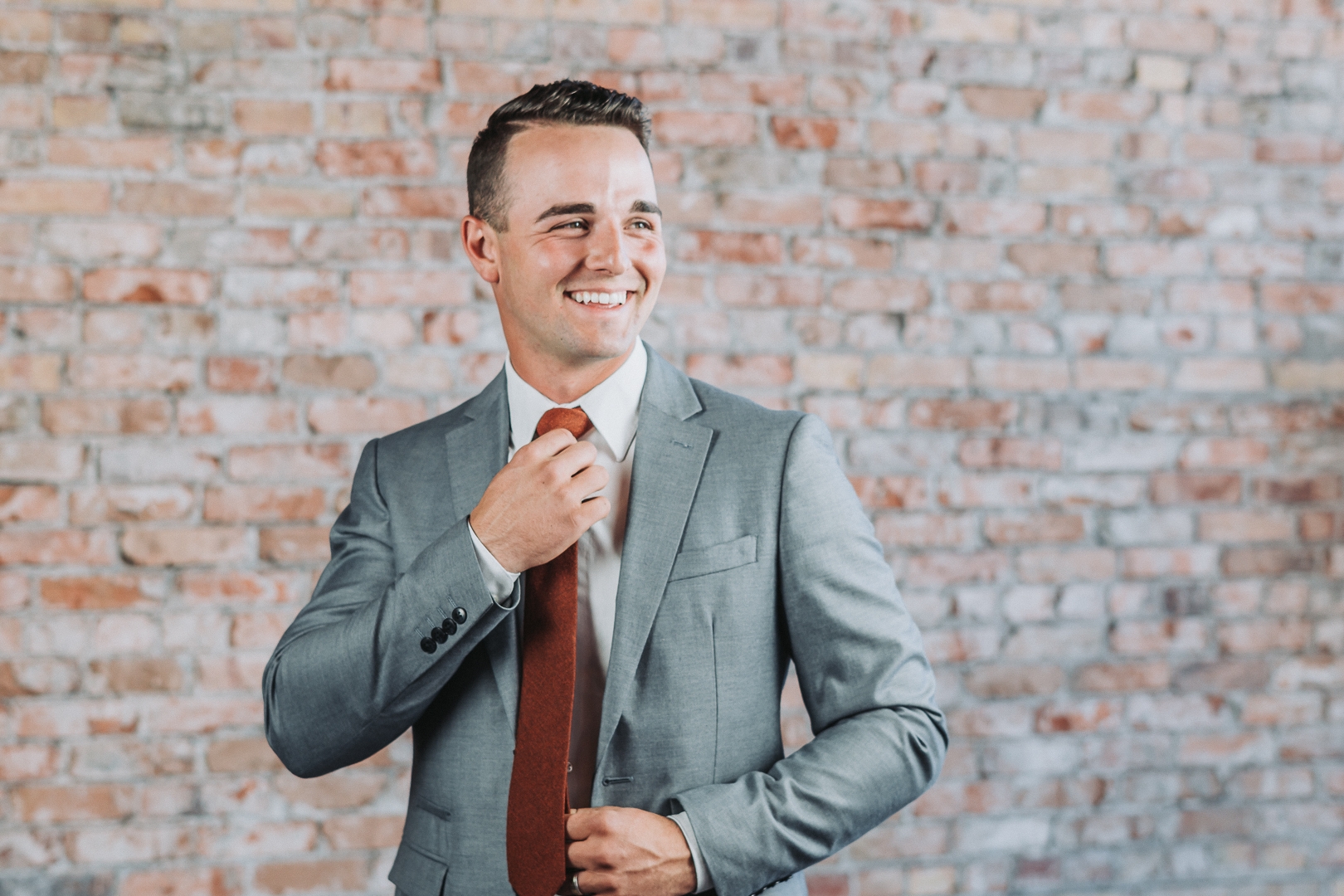 groom formals fixing tie