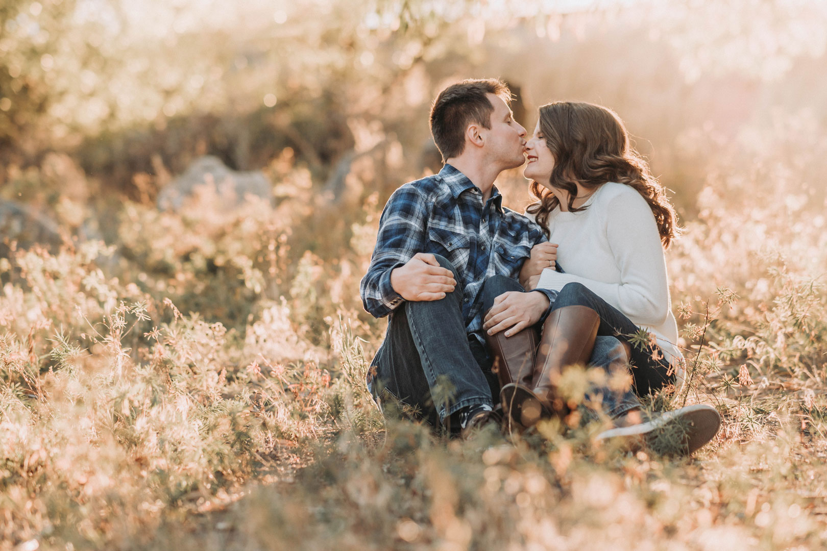 couple kissing with gold sunset in southeast idaho