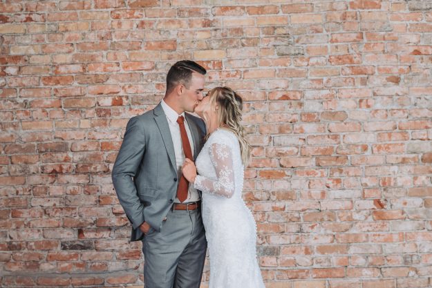 bridals in rigby bride pulling grooms tie