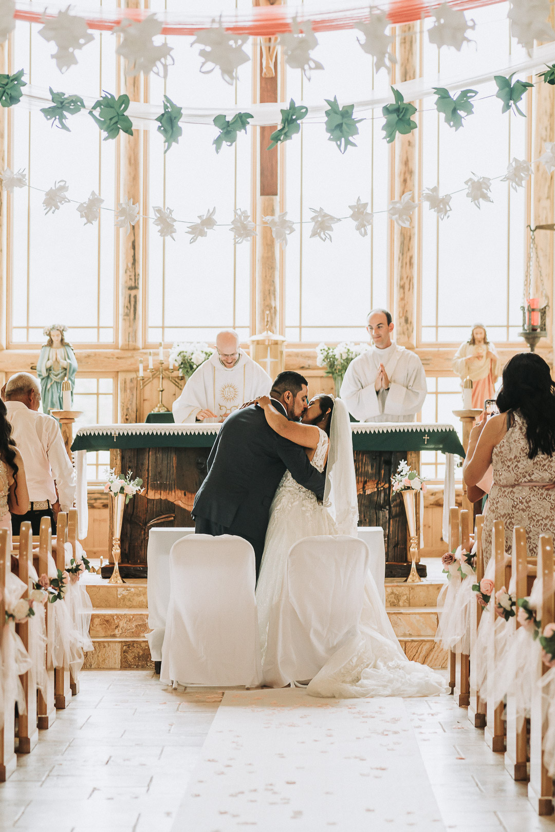 bride and groom kissing at ceremony with 4 hours of wedding photography coverage