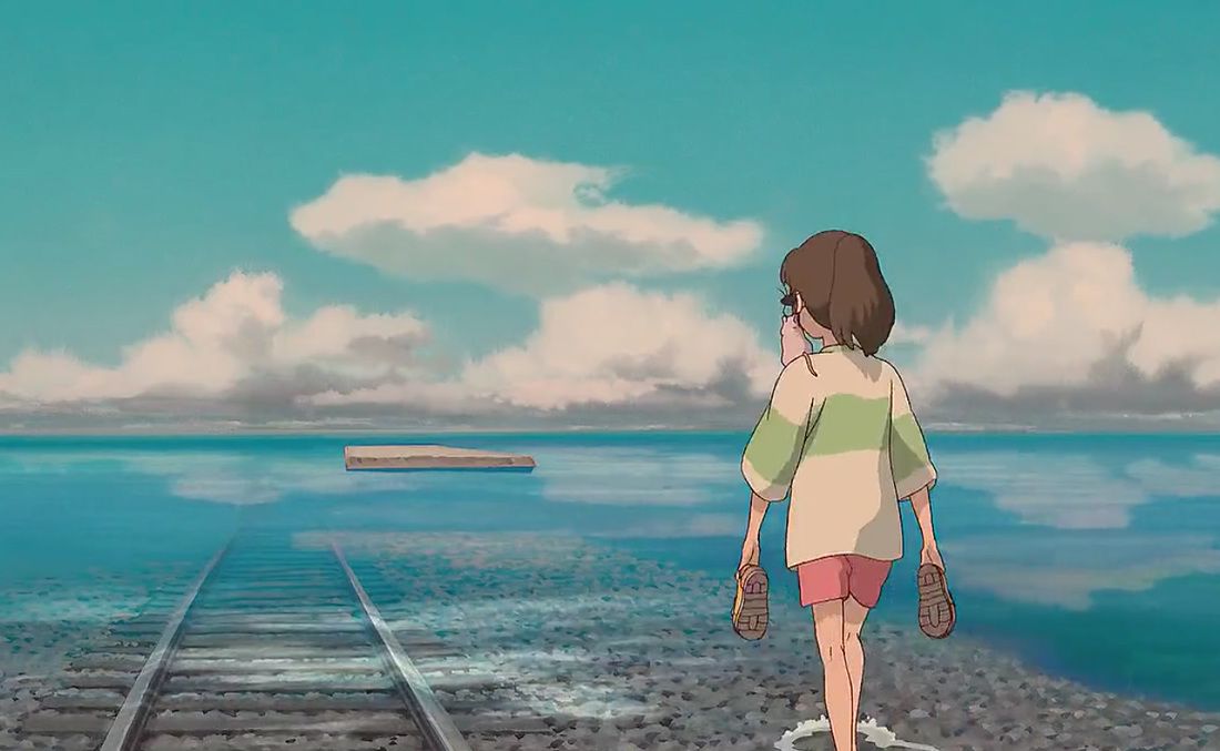 Chihiro walking in shallow water by sunken railroad tracks