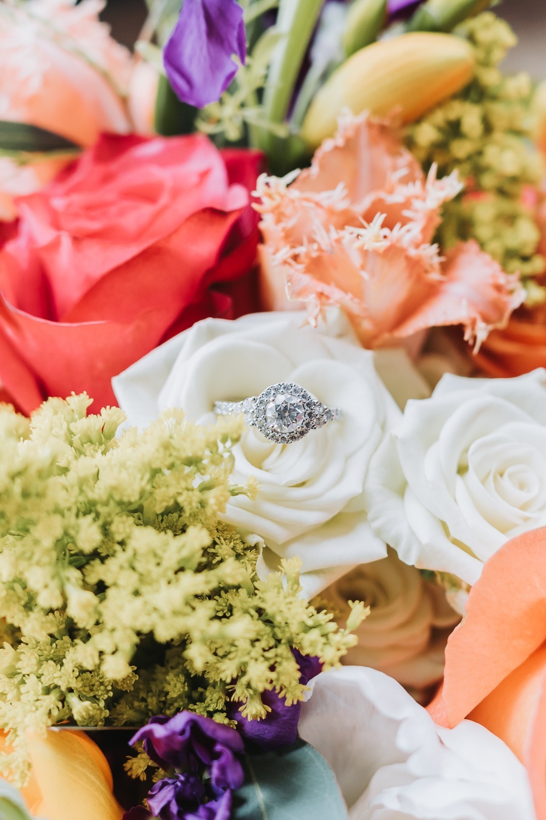 Nampa Wedding colorful florals with wedding ring inside a rose