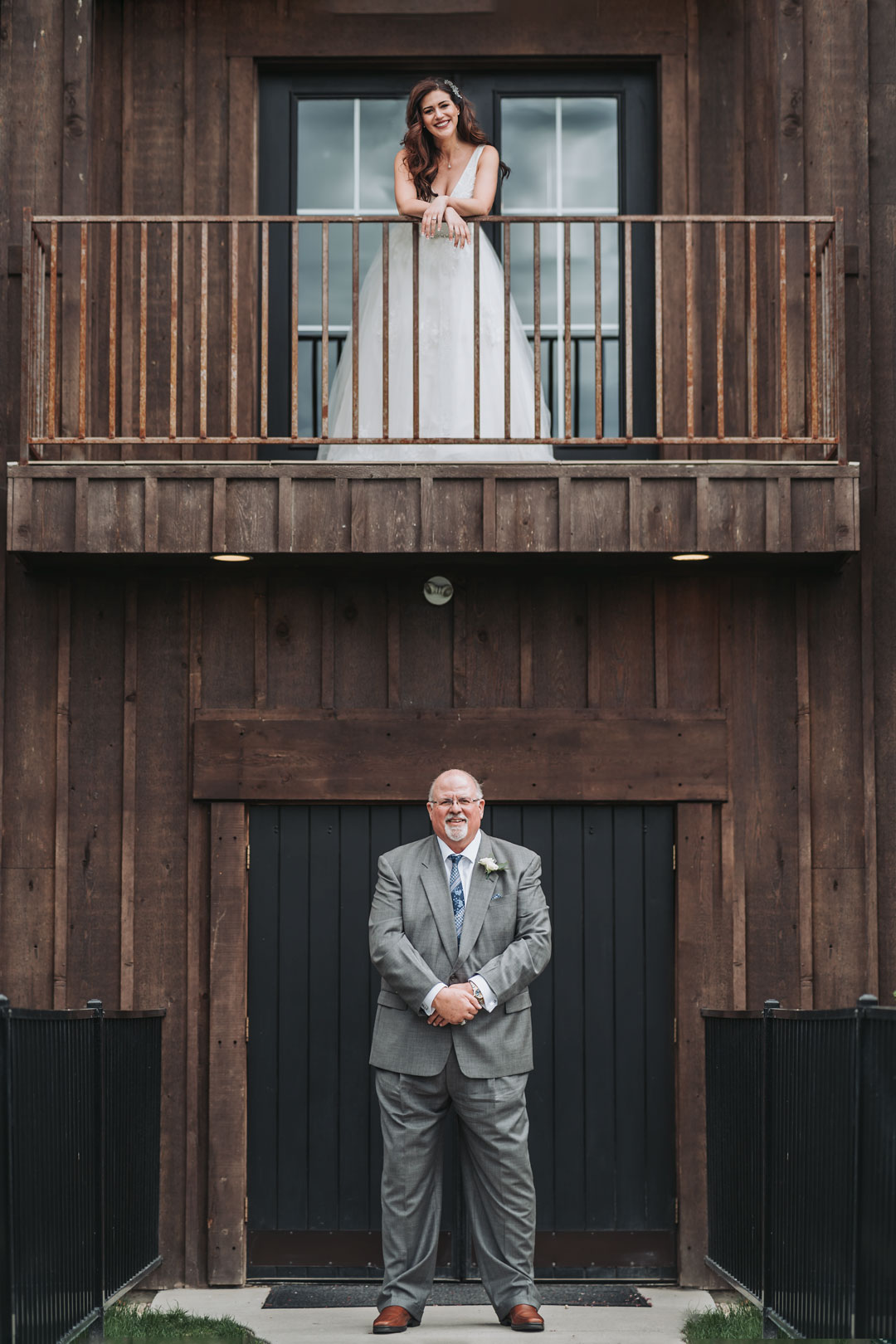 first look wedding photographer bride with father on balcony nampa wedding
