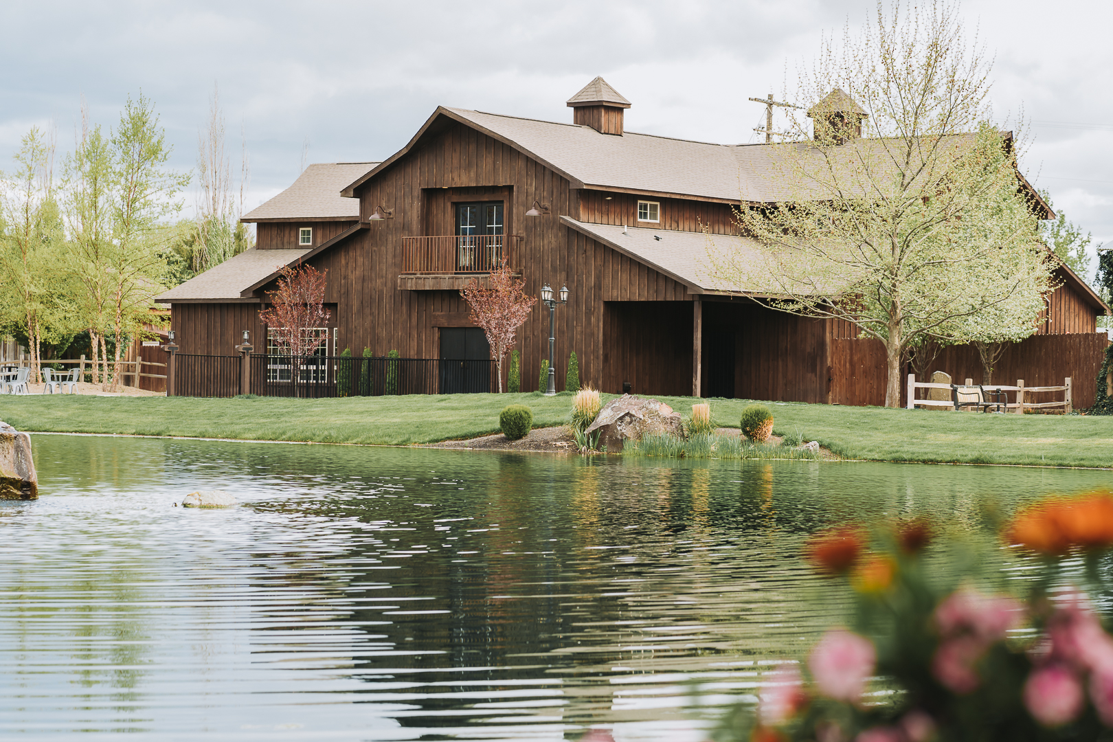 still water hollow nampa wedding venue by a large pond with colorful flowers wedding photographer
