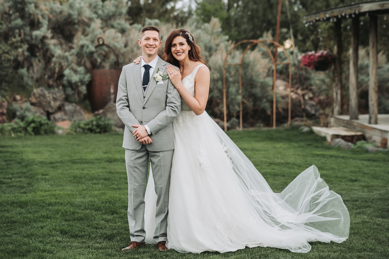formal bride and groom smiling at the camera