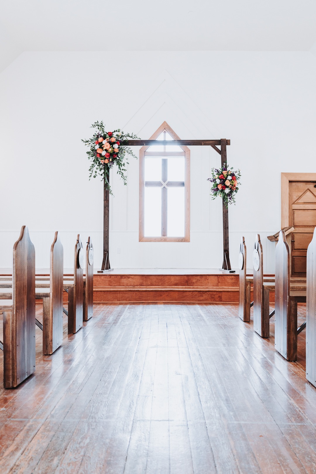 february wedding in chapel with flower arch