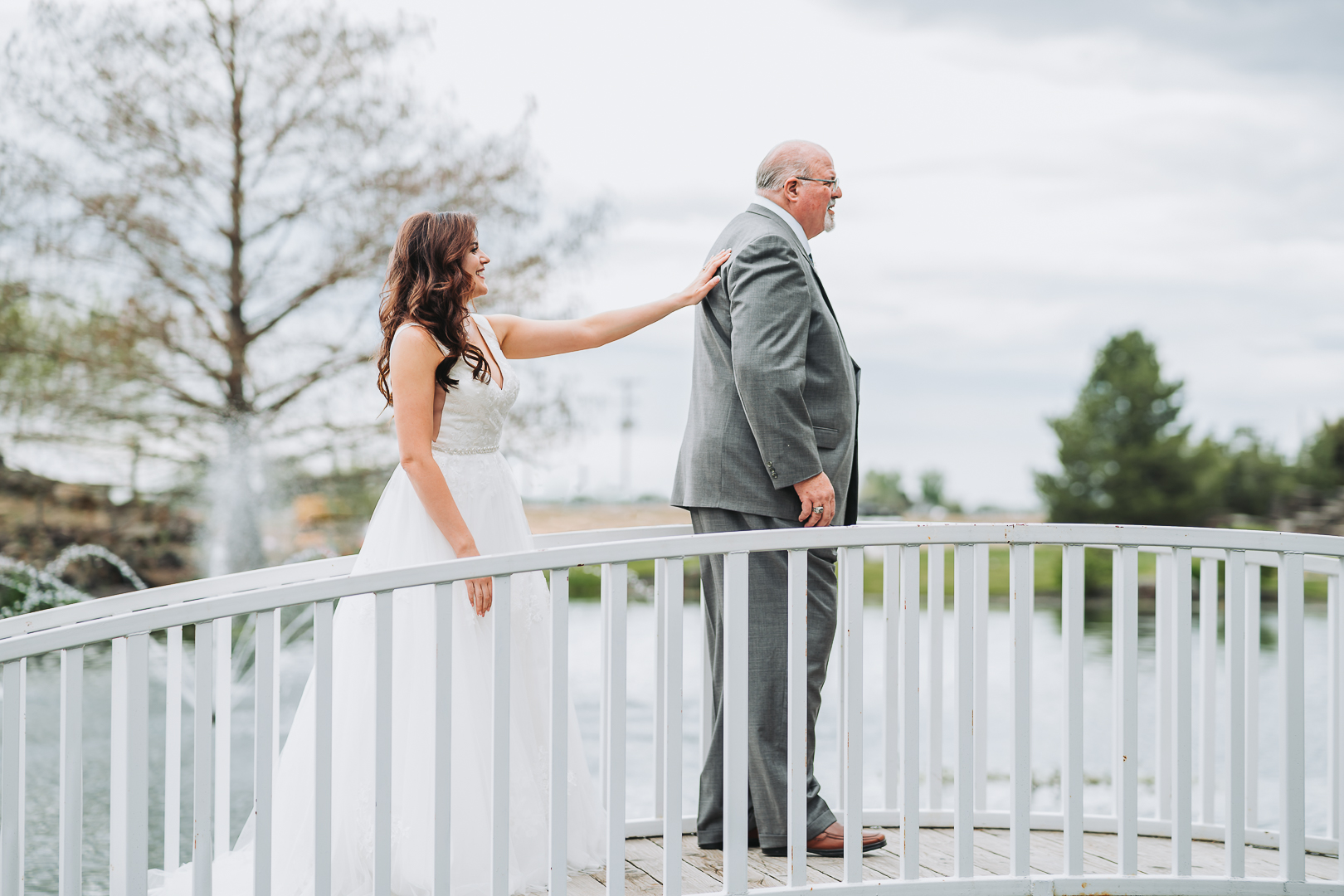 first look with bride and father on bridge still water hollow colorful wedding