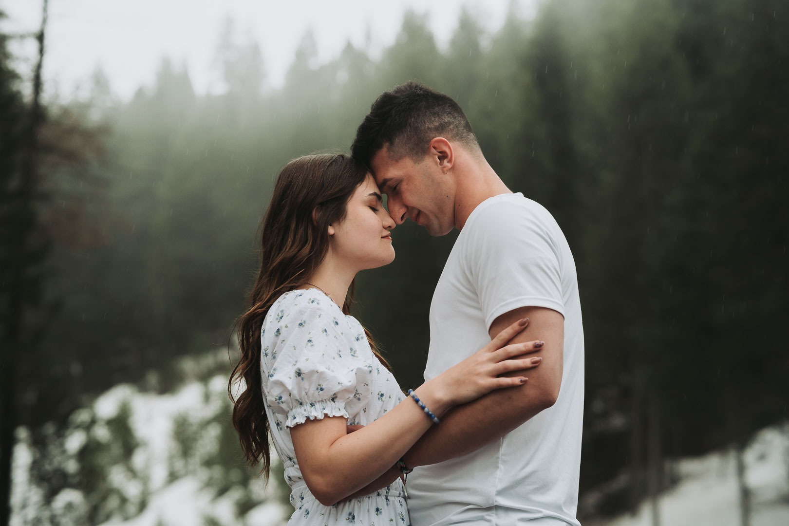 dark and moody Rexburg engagement photos with mountains and fog