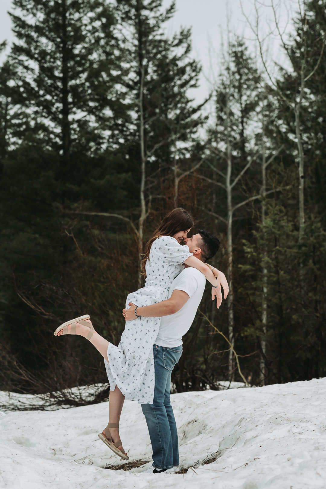 january engagement photos in the snow and pine