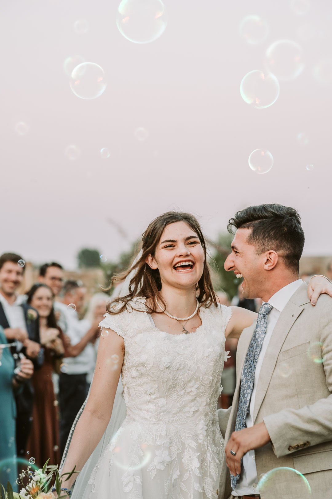 idaho wedding photography bubbles exit bride and groom laughing